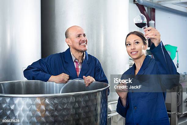 Winery Workers Holding Glass In Wine Factory Stock Photo - Download Image Now - 25-29 Years, 50-59 Years, Adult