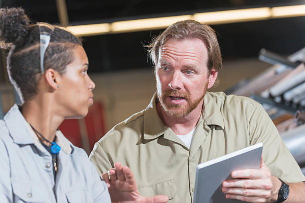 istock Supervisor, digital tablet, talking with female worker 606634360