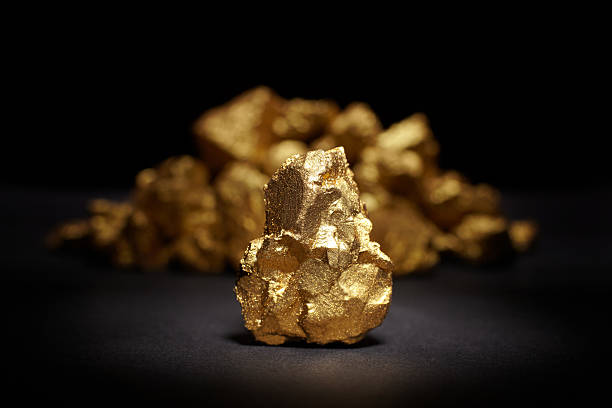 Closeup of big gold nugget Closeup of big gold nugget on a black background gold mine photos stock pictures, royalty-free photos & images