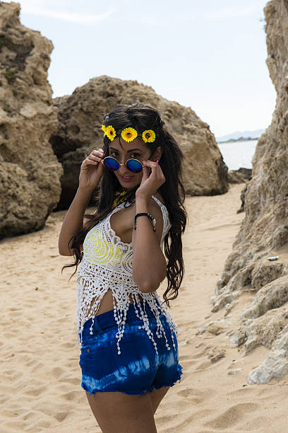 istock Attractive young woman on sandy beach 606636302