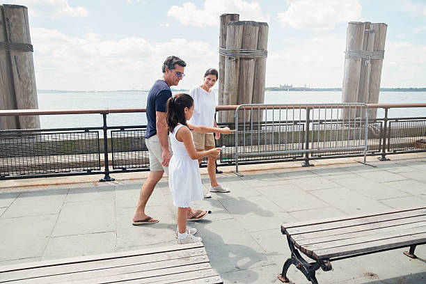 istock Family playing mobile augmented reality game in New-York. 606637800