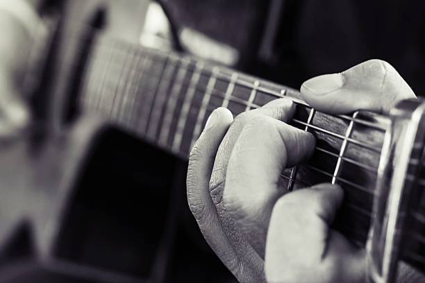 istock Practicing in playing guitar, Hand of young men playing guitar 606639360
