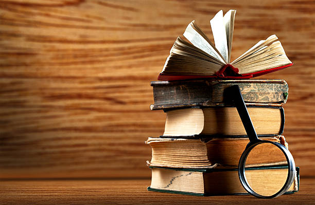 Old books with magnifying glass