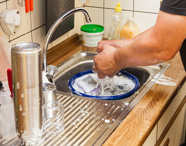 Men hands wash dishes stock photo