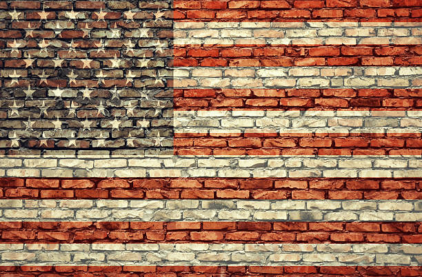 istock American flag on the brick wall 606642506