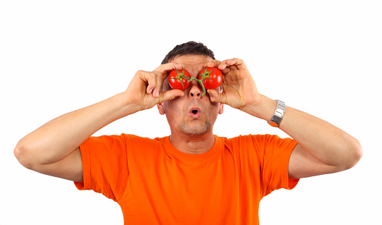 Man with tomatoes on his eyes