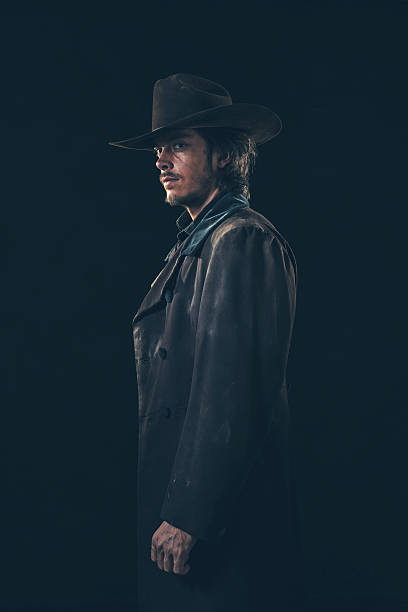 istock Side view of vintage 1900 cowboy. Young man. Studio shot. 606643706
