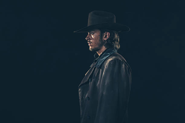istock Side view of vintage 1900 cowboy. Young man. Studio shot. 606646302