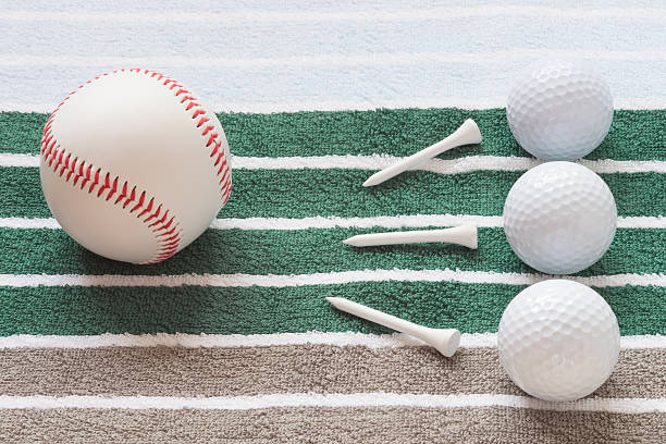 istock balls on a striped background golf and baseball and nails 606647836