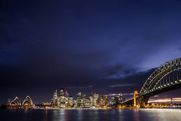 istock Sydney CBD and harbor illuminated at night 606665060
