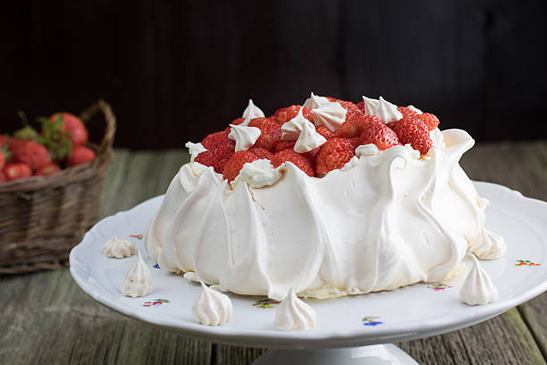 istock Strawberries Pavlova Cake with Whipped Cream on a White Plate 606665644