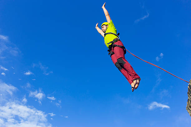 istock Jump rope from a high rock in the mountains. 606665766