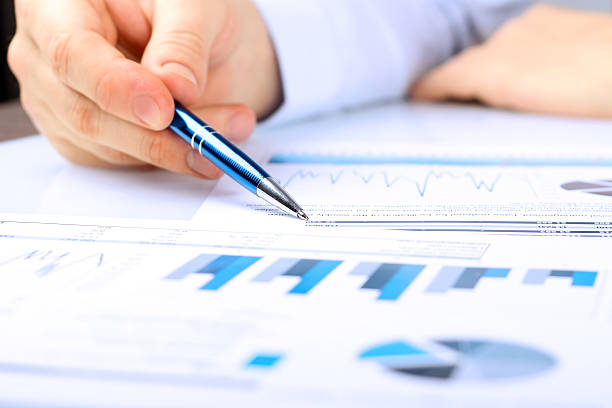 Close-up Of Businessman Analyzing Graph in the office stock photo