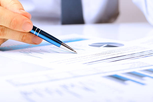 istock Close-up Of Businessman Analyzing Graph in the office 606666954