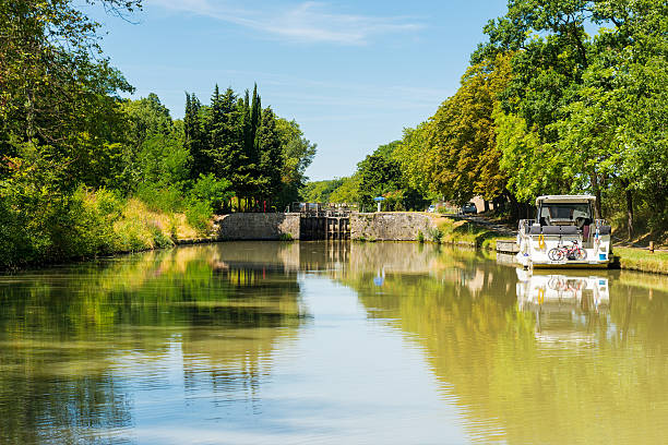 Toulouse, France-08 19 2015:The Canal du Midi in the city of Toulouse.It is a 240 km long canal in Southern France.Originally named the Canal royal en Languedoc (Royal Canal in Languedoc) and renamed by French revolutionaries to Canal du Midi in 1789, the canal was at the time considered one of the greatest construction works of the 17th century.The Canal du Midi was inscribed as a UNESCO World Heritage Site in 1996.