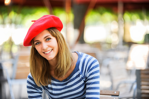 Young tourist woman in Paris wearing red beret