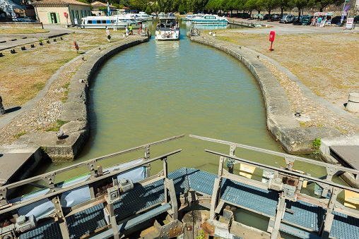 Carcasonne, France - August 3, 2016: a recreational boat just gone through a river lock at canal du midi in carcasonne.