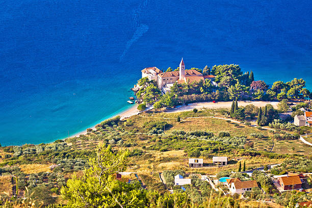 istock Church and beach in Bol aerial view 606670196