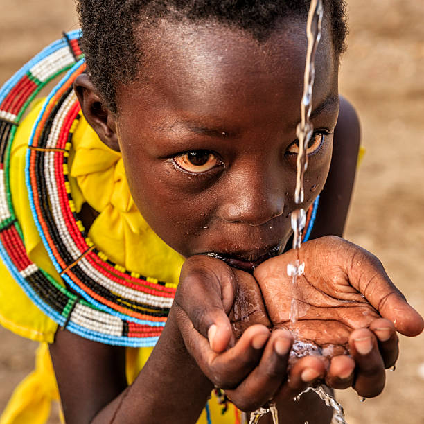 istock African little girl from Samburu tribe drinking fresh 606671594