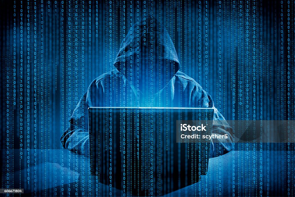 Computer crime concept. Hacker using laptop. Hacking the Internet. Computer Hacker Stock Photo