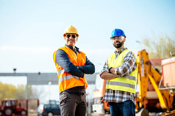 istock Engineer and contractor standing near machinery 606673322