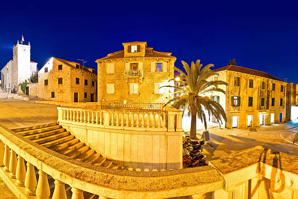 Supetar old stone square evening view Supetar old stone square evening view, island of Brac, Dalmatia, Croatia old catholic church on island brac croatia stock pictures, royalty-free photos & images