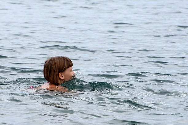 istock Little girl swimming 606673884