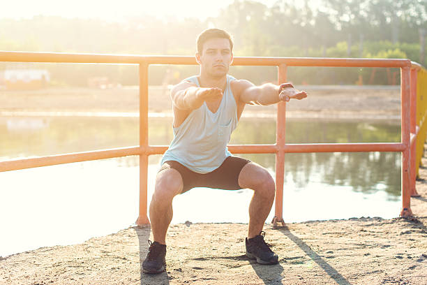 istock Fit man working out glutes with bodyweight workout doing squat 606674006