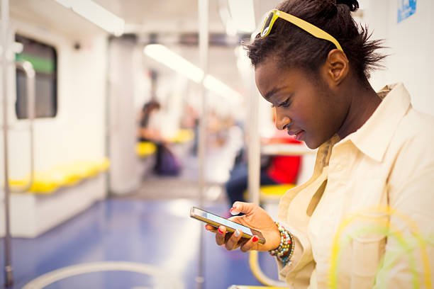 istock Young African European woman using wifi connection in subway tra 606677886