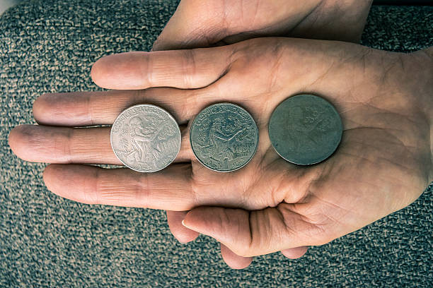 istock Three Tunisian coins on the woman's palm 606679918