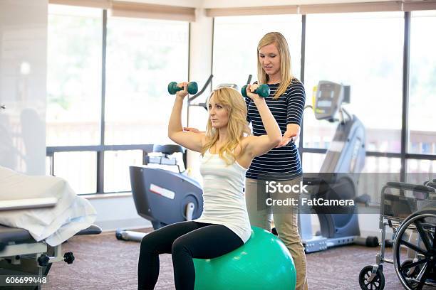 Young Female Pt Working With A Female Patient Stock Photo - Download Image Now - Physical Therapy, Recovery, Strength