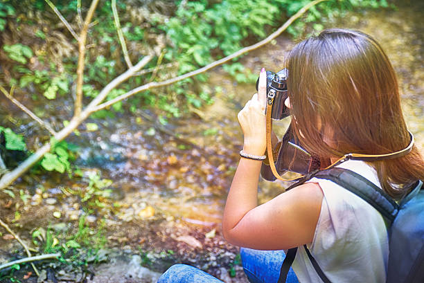 istock Women photograph in the woods 606702232