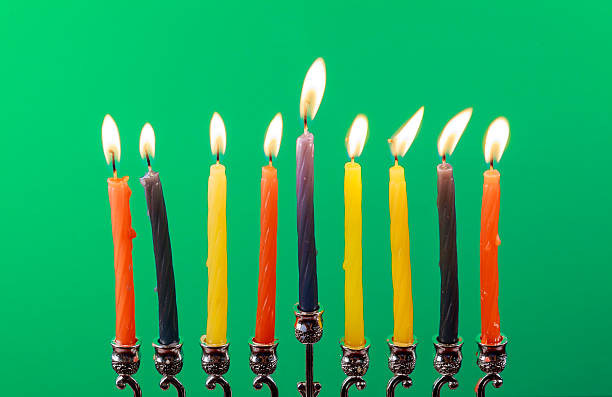 istock Hanukkah menorah with candles green background isolation 606703926