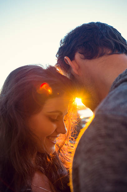 istock Couple embracing at sunrise. 606705016