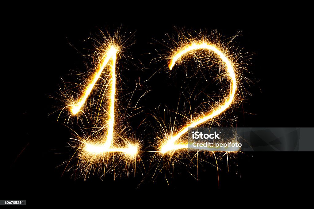 Number 12 made with sparklers Number 12 made with sparklers  on black background Anniversary Stock Photo