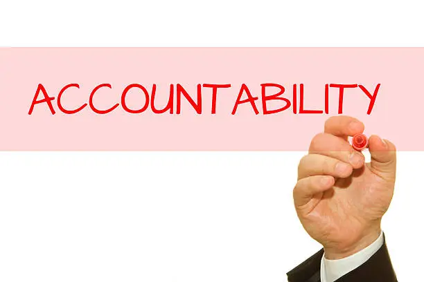 Photo of Businessman hand writing Accountability with a marker.