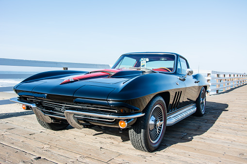 Pismo Beach, California, United States - June 21, 2014: Black 1967 Corvette on the pier at PIsmo Beach
