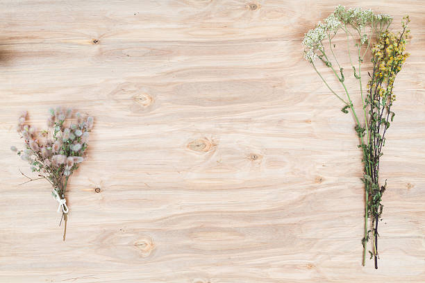 istock Dry flowers and herbs collage composition at wooden desk 606708608