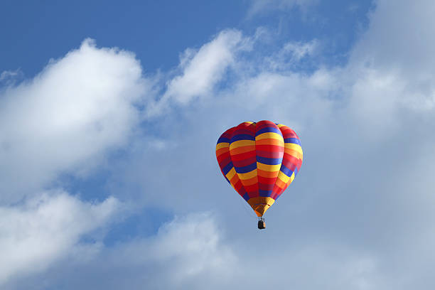 istock Multi colorful hot air balloon floating in the clouds 606709620