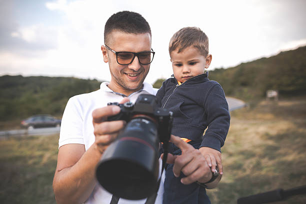 istock Photographer father and his son 606710022