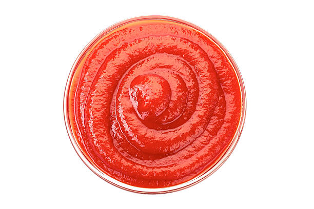 istock Bowl of ketchup or tomato sauce on white 606710456