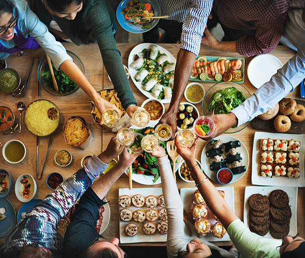 istock Friends Happiness Enjoying Dinning Eating Concept 606713564