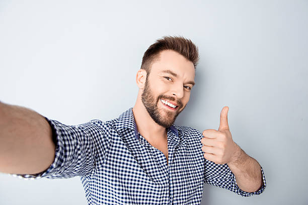 istock Happy man making selfie and showing thumb up 606714164