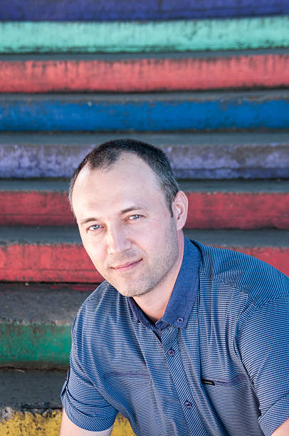 istock Middle-aged man on a colorful background 606714188