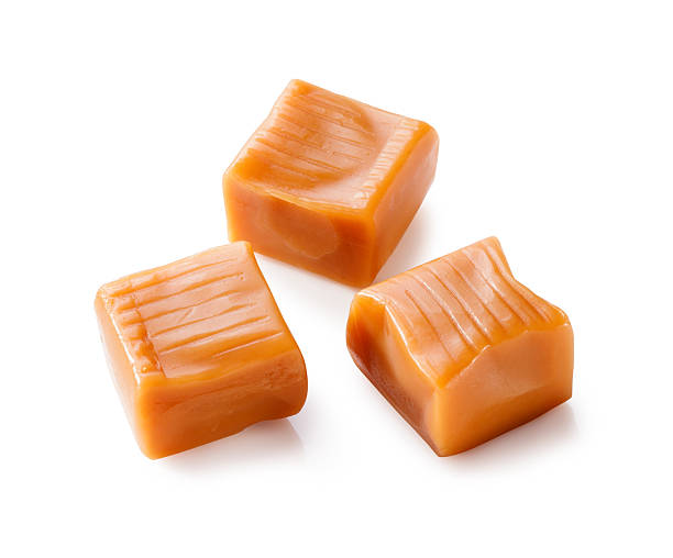 istock toffee caramel candies close-up isolated on white background 606723252