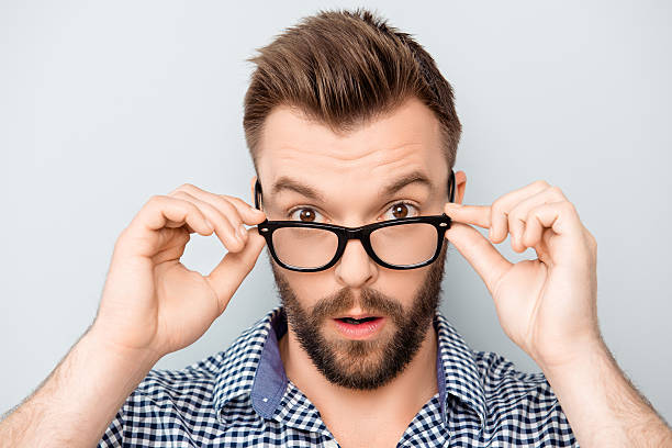 istock Portrait of shocked modern man touching his spectacles 606728142