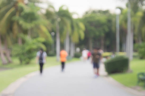 istock Blured people jogging in park 606739142