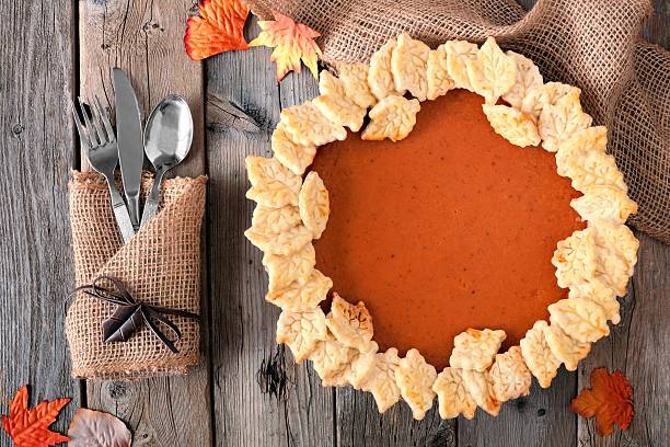 istock Pumpkin pie with autumn leaf pastry design, overhead table scene 606739886