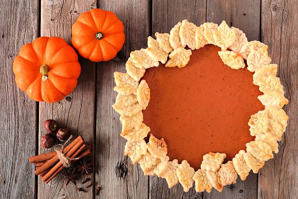istock Pumpkin pie with autumn leaf pastry design, overhead scene 606740022