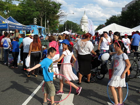 Washington DC, USA-September 18, 2016:  These people are waiting in line for free food samples at the Fiesta DC Latino Festival on Pennsylvania Avenue in Washington DC.  Fiesta DC is a two day event with a parade on Saturday and a street festival on Sunday.  This is the street festival on Sunday featuring food, music and free giveaways.  The festival is free.